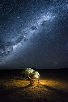 Tourist camping outdoor admiring the stars of the Southern Hemisphere, Namibia, Africa Tourist camping outdoor admiring the stars of the Southern Hemisphere, Namibia, Africa