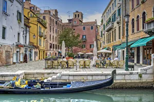 Tourists seated in an outdoor cafe in a small square of Venice, Veneto, Italy Tourists seated in an outdoor cafe in a small square of Venice, Veneto, Italy