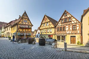 Tourists on Spitalgasse street with Plonlein half-timbered buildings Tourists on Spitalgasse street with Plonlein half-timbered buildings