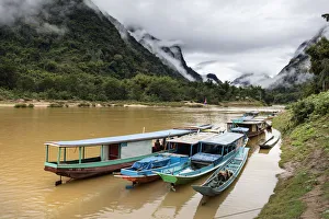 Traditional longboats moored up on Nam Ou river, Nong Khiaw, Luang Prabang Province Traditional longboats moored up on Nam Ou river, Nong Khiaw, Luang Prabang Province