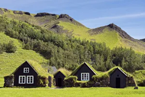 Turf roofed houses under mountain range at Skogar Museum, Skogar, Rangarping eystra, Southern Region, Iceland Turf roofed houses under mountain range at Skogar Museum, Skogar, Rangarping eystra, Southern Region, Iceland