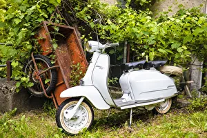 Two-seater Lambretta Innocenti scooter in a courtyard, Morbegno, province of Sondrio Two-seater Lambretta Innocenti scooter in a courtyard, Morbegno, province of Sondrio