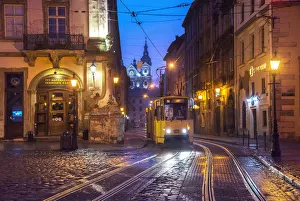 Prints of Ukraine, Lviv, Electric Commuter Trolley, Medieval Cobblestone Streets, Lviv Survived Soviet And German Occupations Unscathed During World War II, Lviv Is One Of The Main Cultural Centers Of Ukraine Ukraine Prints: Lviv Electric Commuter Trolley Print