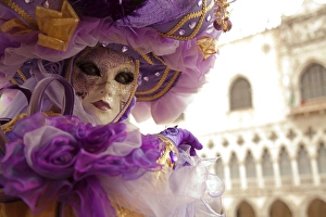 Venice, Veneto, Italy; A masked character in front of the Palazzo dei Dogi during Carnival Venice, Veneto, Italy; A masked character in front of the Palazzo dei Dogi during Carnival