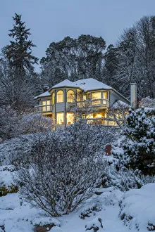 Victorian style lighted house framed in a snowy landscape, Bremerton, Washington, USA Victorian style lighted house framed in a snowy landscape, Bremerton, Washington, USA