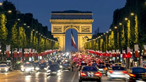 View down the Champs Elysees to the Arc de Triomphe, illuminated at dusk, Paris, France View down the Champs Elysees to the Arc de Triomphe, illuminated at dusk, Paris, France