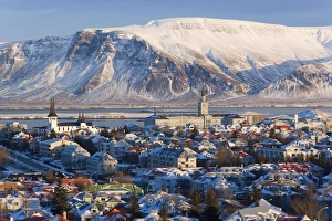 Prints of View over Reykjavik in winter, Iceland Iceland, Reykjavik, elevated view over the Churches and cityscape of Reykjavik with a backdrop of snow capped mountains Iceland Prints: Reykjavik Winter Cityscape Print