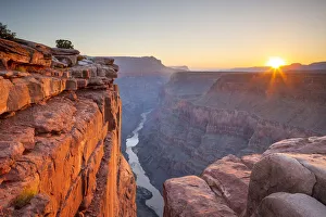 View of the sun rising over the Grand Canyon and Colorado River View of the sun rising over the Grand Canyon and Colorado River