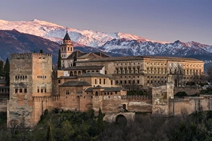View at sunset of Alhambra palace with the snowy Sierra Nevada in the background View at sunset of Alhambra palace with the snowy Sierra Nevada in the background