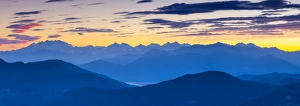 View towards Swiss Alps from Monte San Salvatore illuminated at sunset, Lugano View towards Swiss Alps from Monte San Salvatore illuminated at sunset, Lugano