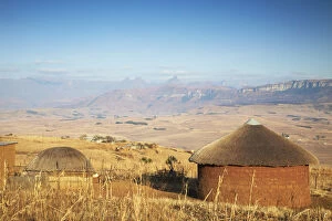 Cape Floral Region Protected Areas Collection: Village huts with Cathedral Peak in background, Ukhahlamba-Drakensberg Park, KwaZulu-Natal