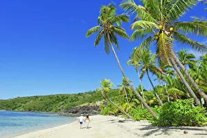 Walking on a tropical beach, Drawaqa Island, Yasawa island group, Fiji, South Pacific Walking on a tropical beach, Drawaqa Island, Yasawa island group, Fiji, South Pacific