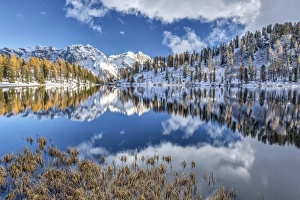 The still water of Lake Malghette reflecting the Brenta Dolomites peaks in autumn The still water of Lake Malghette reflecting the Brenta Dolomites peaks in autumn