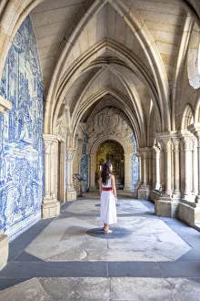 A woman admires the cloister arcades of Porto Cathedral (Sao do Porto), Porto A woman admires the cloister arcades of Porto Cathedral (Sao do Porto), Porto