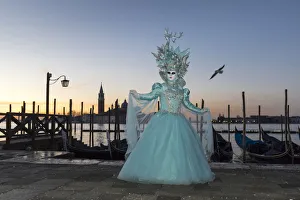 Woman in costume during Carnival at dawn, Piazza San Marco (St. Marks Square) Woman in costume during Carnival at dawn, Piazza San Marco (St. Marks Square)