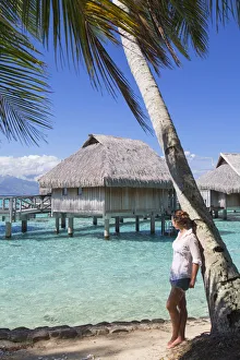 Woman looking at overwater bungalows of Sofitel Hotel, Moorea, Society Islands, French Woman looking at overwater bungalows of Sofitel Hotel, Moorea, Society Islands, French