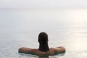 Woman relaxing in infinity pool. Rangiroa, Tuamotu Archipelago, French Polynesia. (MR) Woman relaxing in infinity pool. Rangiroa, Tuamotu Archipelago, French Polynesia. (MR)