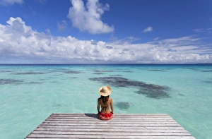 Woman sitting on jetty, Fakarava, Tuamotu Islands, French Polynesia (MR) Woman sitting on jetty, Fakarava, Tuamotu Islands, French Polynesia (MR)
