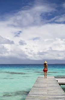 Woman walking on jetty, Fakarava, Tuamotu Islands, French Polynesia (MR) Woman walking on jetty, Fakarava, Tuamotu Islands, French Polynesia (MR)