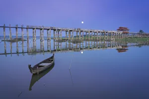 Wooden boat by U Bein bridge against sky, Amarapura, Amarapura Township, Mandalay Wooden boat by U Bein bridge against sky, Amarapura, Amarapura Township, Mandalay