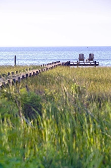 Wooden pier and chairs, Apalachicola Bay, Florida Panhandle, USA Wooden pier and chairs, Apalachicola Bay, Florida Panhandle, USA