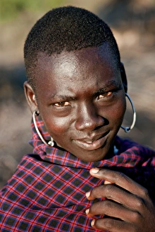 A young Pokot warrior with large round earrings. The Pokot are pastoralists speaking a Southern Nilotic A young Pokot warrior with large round earrings. The Pokot are pastoralists speaking a Southern Nilotic