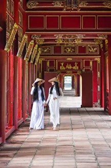 Two young women wearing traditional national costume, ao dai, in the Imperial City Two young women wearing traditional national costume, ao dai, in the Imperial City