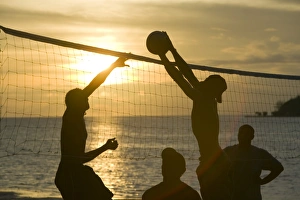 Fijian men playing beach volleyball at sunset at the Walu Beach Resort on Malolo Island off Fiji Fijian men playing beach volleyball at sunset at the Walu Beach Resort on Malolo Island off Fiji