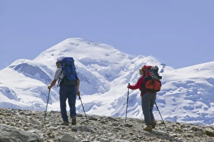 Hikers in front of Mont Blanc above Chamonix France. Like all of the alps its glaciers are melting rapidly due to Hikers in front of Mont Blanc above Chamonix France. Like all of the alps its glaciers are melting rapidly due to