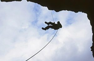 A man abseiling in Rydal Cave in the Lake District UK A man abseiling in Rydal Cave in the Lake District UK
