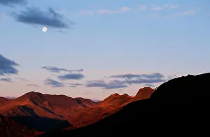 The moon over Bowfell and the Langdale Pikes in the Lake district UK The moon over Bowfell and the Langdale Pikes in the Lake district UK
