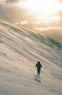 A mountaineer on Seat Sandal in the Lake District UK in winter weather A mountaineer on Seat Sandal in the Lake District UK in winter weather