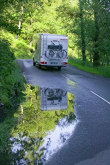 Reflections in a puddle on a road in the Trossachs Scotland UK Reflections in a puddle on a road in the Trossachs Scotland UK