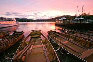Rowing boats at Waterhead Ambleside on Lake Windermere at sunset in the Lake District UK Rowing boats at Waterhead Ambleside on Lake Windermere at sunset in the Lake District UK