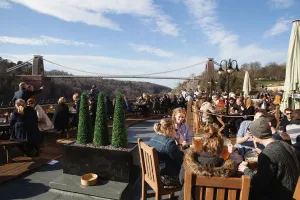 Prints of England, Bristol, Drinkers on the terrace of the White Lion Bar with a view of the Clifton Suspension Bridge Clifton Prints: Print of Drinkers on the Clifton Suspension Bridge Terrace