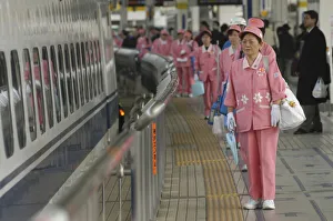 Japan Tokyo Ccleaning crew of middle aged women in uniform wait to board a shinkansen Japan Tokyo Ccleaning crew of middle aged women in uniform wait to board a shinkansen