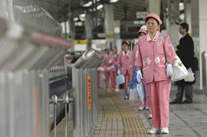 Japan Tokyo Middle aged woman part of cleaning crew Japan Tokyo Middle aged woman part of cleaning crew