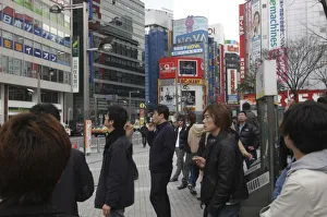 Japan Tokyo Shinjuku Outside station smokers light up at a smoking station Japan Tokyo Shinjuku Outside station smokers light up at a smoking station