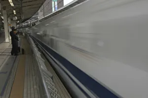 Japan Tokyo Station a nozomi shinkansen bullet train leaves the station watched by JR Japan Tokyo Station a nozomi shinkansen bullet train leaves the station watched by JR