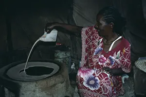 SUDAN, East Ethiopian refugee woman making Sudanese flat bread or Kisra SUDAN, East Ethiopian refugee woman making Sudanese flat bread or Kisra