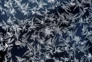 Print of a window with frost pattern atop the Zugspitze mountain