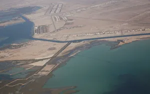 An aerial view of Arabian Gulf with city of Abu Dhabi is pictured through the window of An aerial view of Arabian Gulf with city of Abu Dhabi is pictured through the window of