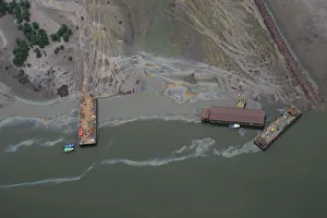 An aerial view shows boats and barges used to help plug an oil leak in the waterways of An aerial view shows boats and barges used to help plug an oil leak in the waterways of