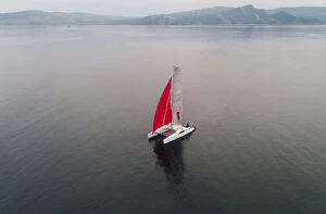 Russia Collection: Aerial view shows a couple traveling on a sailing catamaran along the Yenisei River