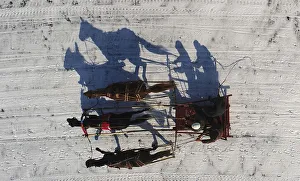An aerial view shows a Russian Troika competing during an amateur horse race near An aerial view shows a Russian Troika competing during an amateur horse race near