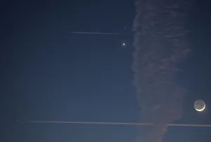 Aircraft fly past with the crescent moon and planets Venus Aircraft fly past with the crescent moon and planets Venus