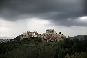The ancient Parthenon temple is seen atop the Acropolis hill under storm clouds in Athens The ancient Parthenon temple is seen atop the Acropolis hill under storm clouds in Athens