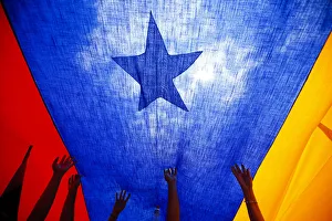Anti-government protesters hold a national flag during a rally against Venezuela's Anti-government protesters hold a national flag during a rally against Venezuela's