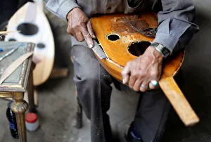 Artisan Mohammed Karam works on an oud in front of a workshop in Cairo Artisan Mohammed Karam works on an oud in front of a workshop in Cairo