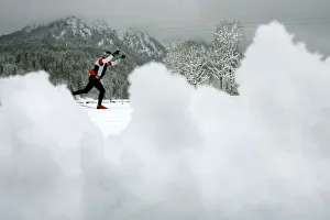 An athlete tries to make his way after heavy snow falls at the cross country race track An athlete tries to make his way after heavy snow falls at the cross country race track